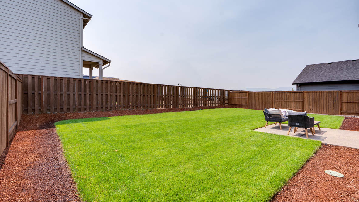 Bailey Meadows backyard with grass and outdoor patio furniture
