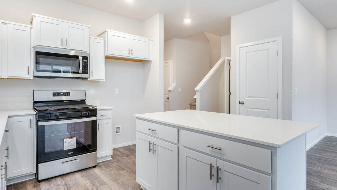 East Park Village kitchen with white shaker style cabinets and white quartz countertops