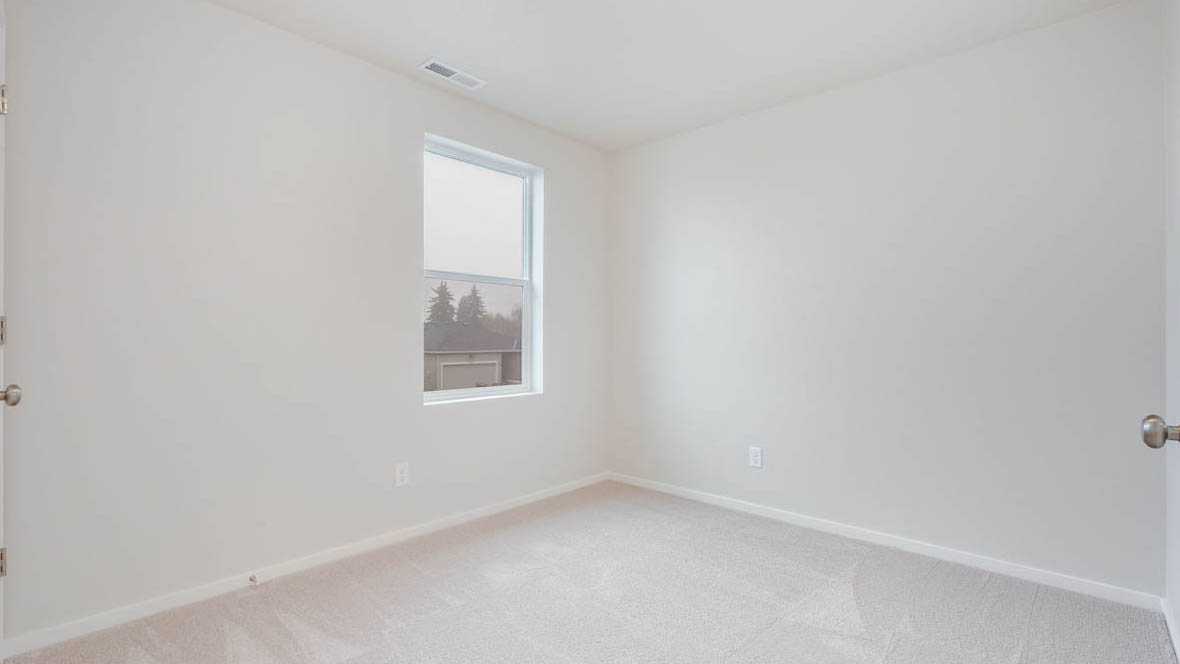 East Park Village bedroom with white carpeting, white walls, and white closet doors