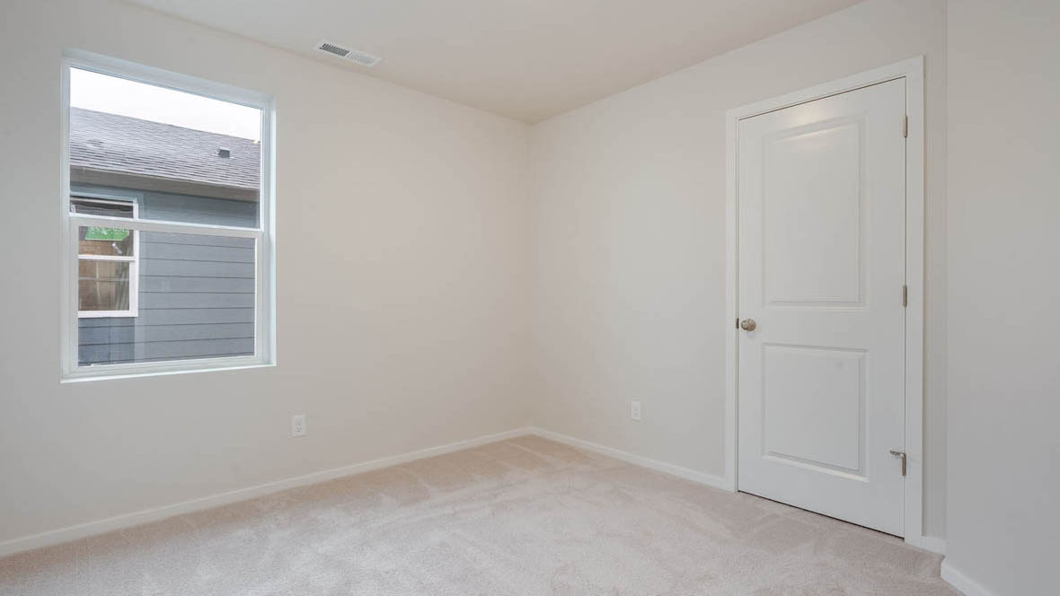 East Park Village bedroom with white carpeting, white walls, and white closet doors