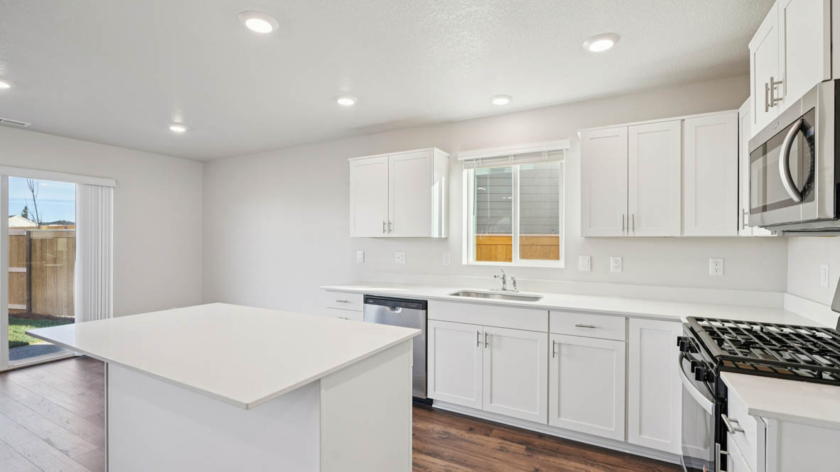 East Park Village kitchen with white shaker style cabinets and white quartz countertops