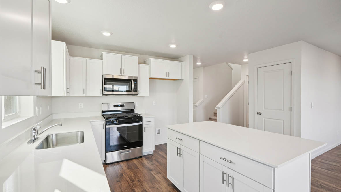East Park Village kitchen with white shaker style cabinets and white quartz countertops