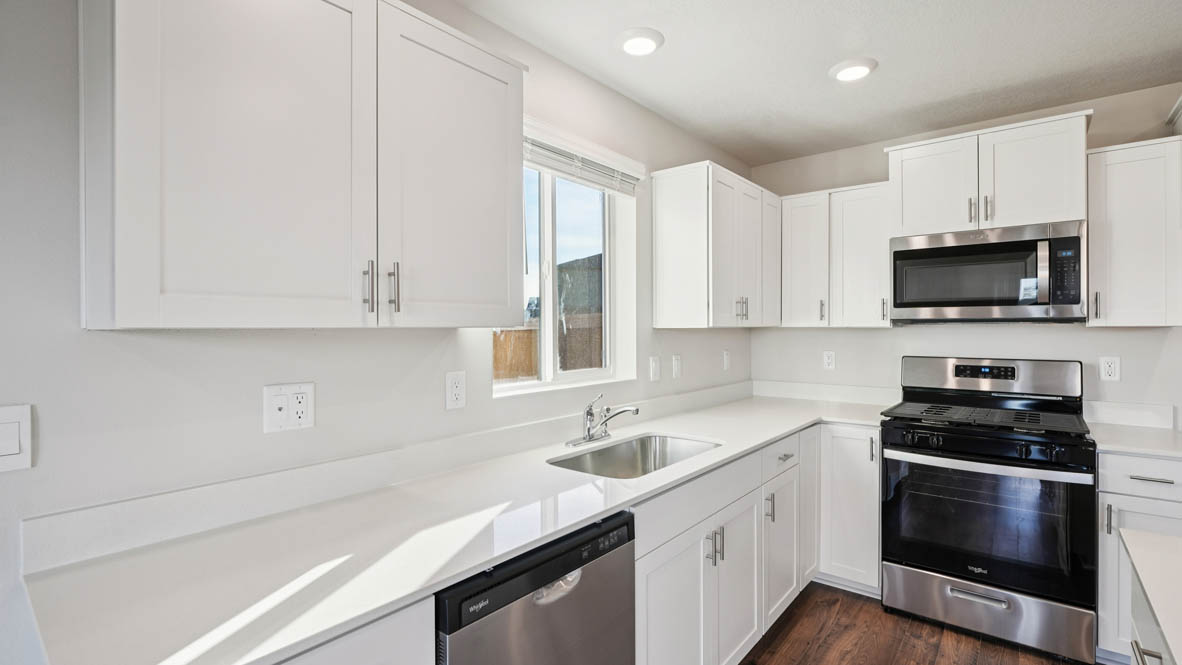 East Park Village kitchen with white shaker style cabinets and white quartz countertops