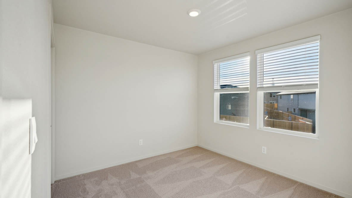 East Park Village bedroom with white carpeting, white walls, and white closet doors