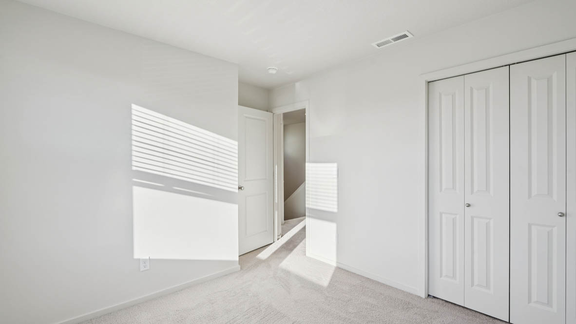 East Park Village bedroom with white carpeting, white walls, and white closet doors