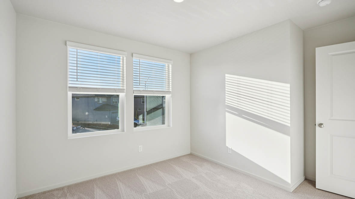 East Park Village bedroom with white carpeting, white walls, and white closet doors