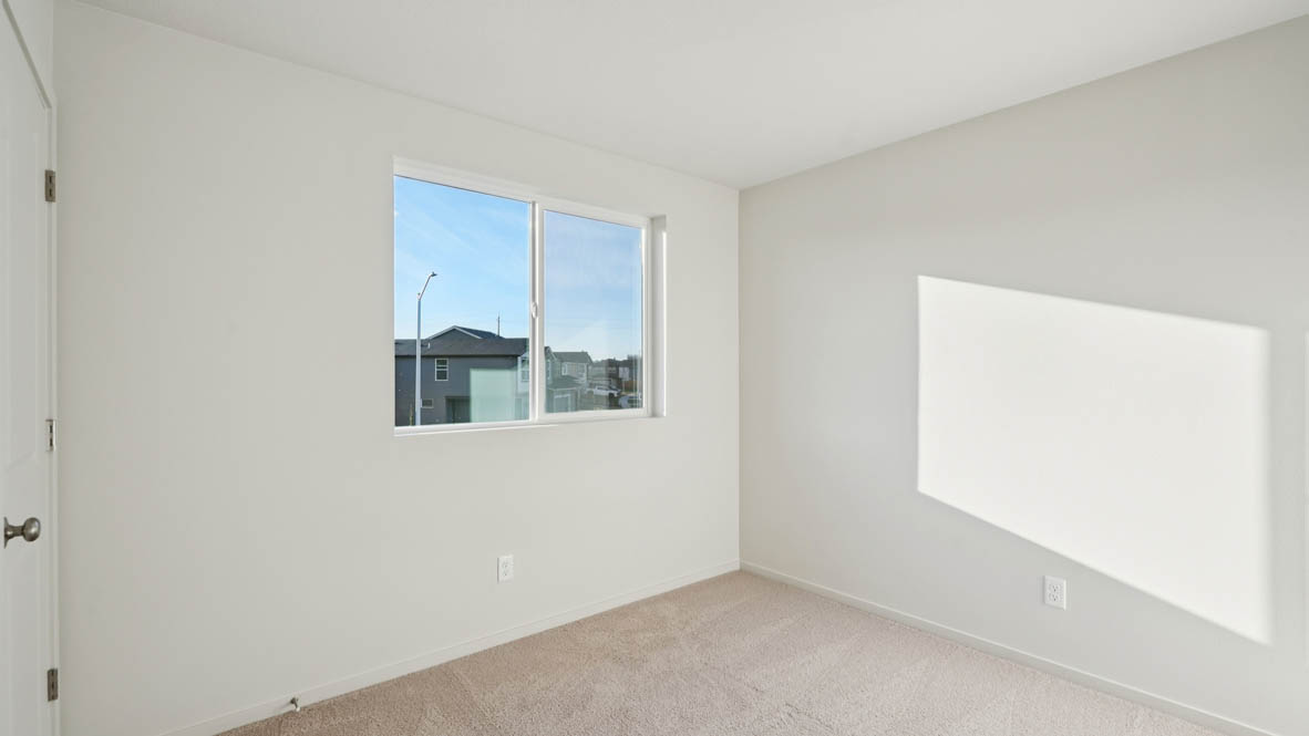 East Park Village bedroom with white carpeting, white walls, and white closet doors