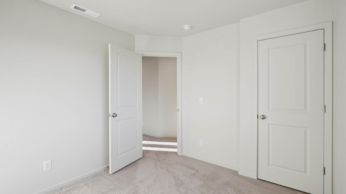 East Park Village bedroom with white carpeting, white walls, and white closet doors
