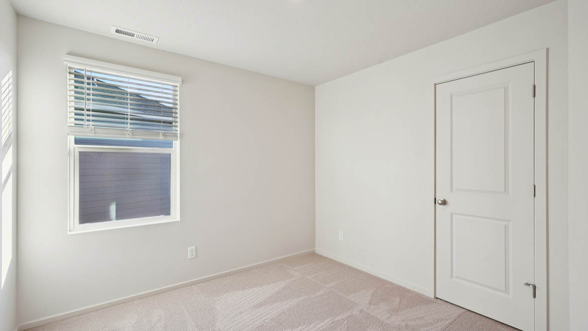 East Park Village bedroom with white carpeting, white walls, and white closet doors