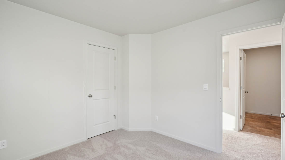 East Park Village bedroom with white carpeting, white walls, and white closet doors