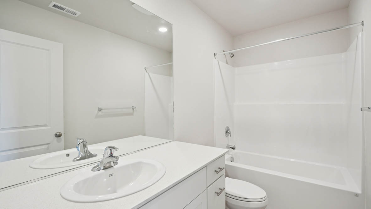 East Park Village Secondary bathroom with single sink vanity and tub shower