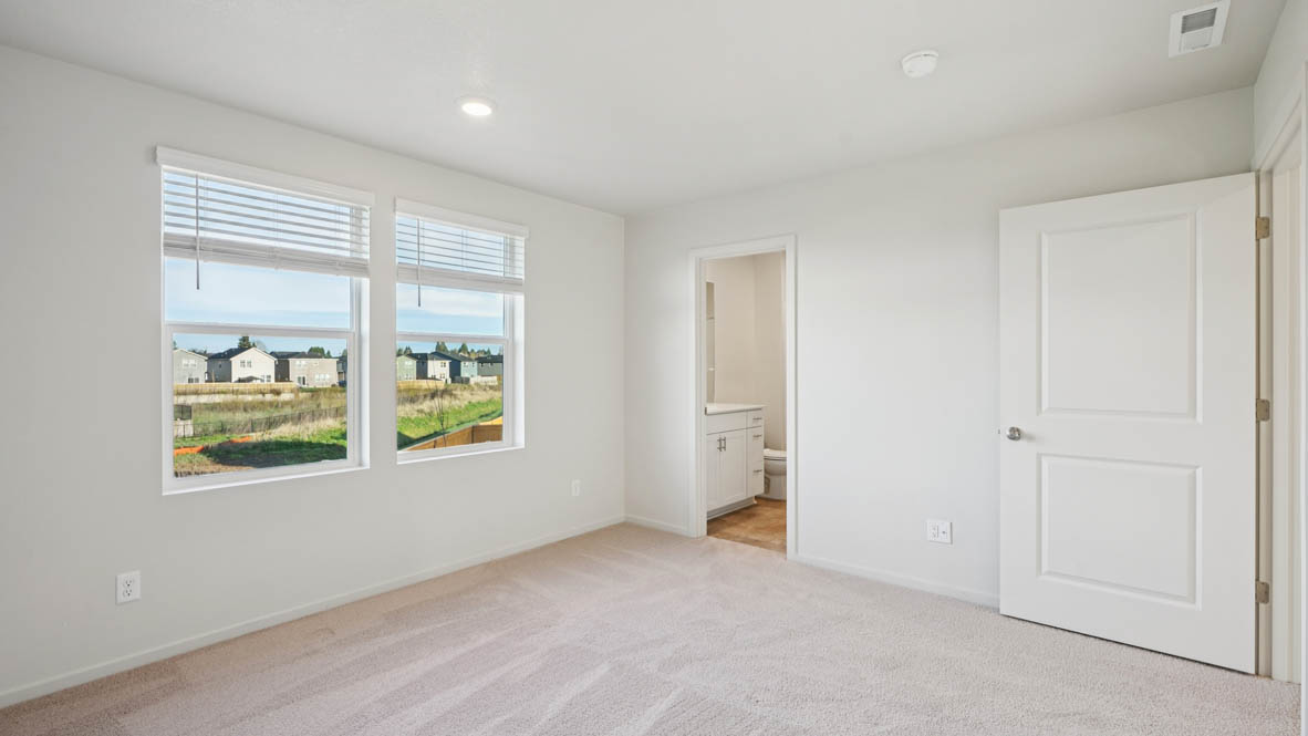 East Park Village primary bedroom with white carpeting, white walls and en suite bathroom