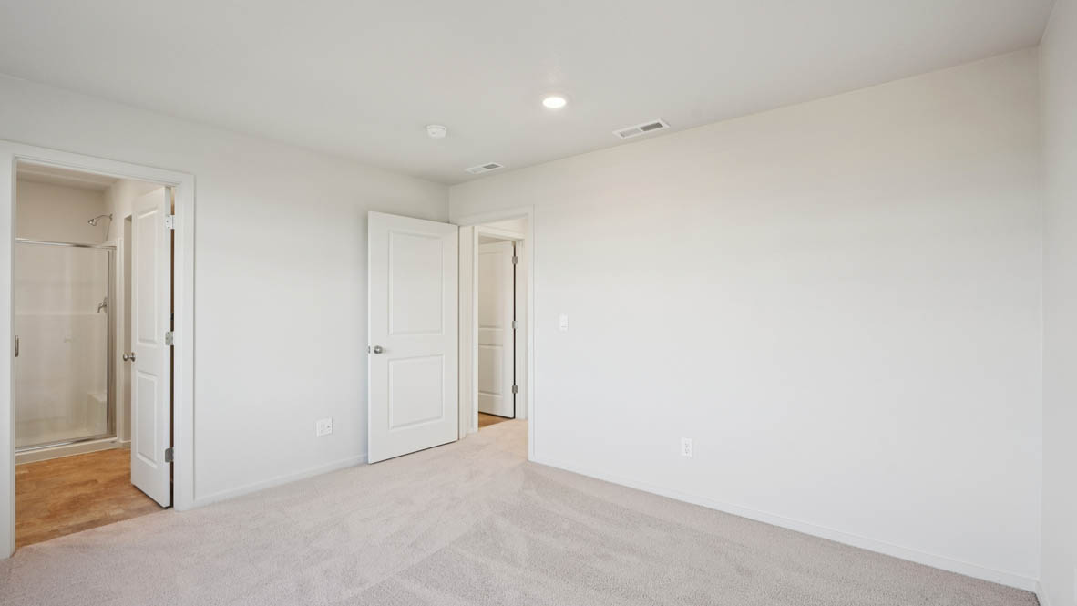 East Park Village primary bedroom with white carpeting, white walls and en suite bathroom