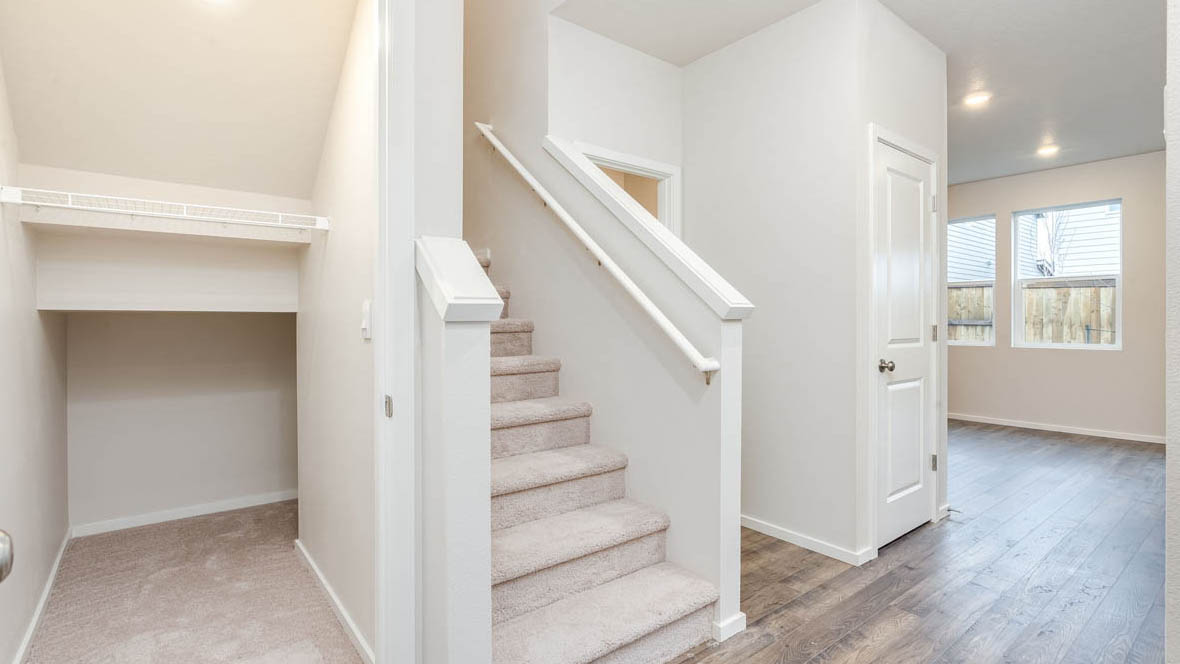 East Park Village with laminate flooring, white walls, and carpet stairs