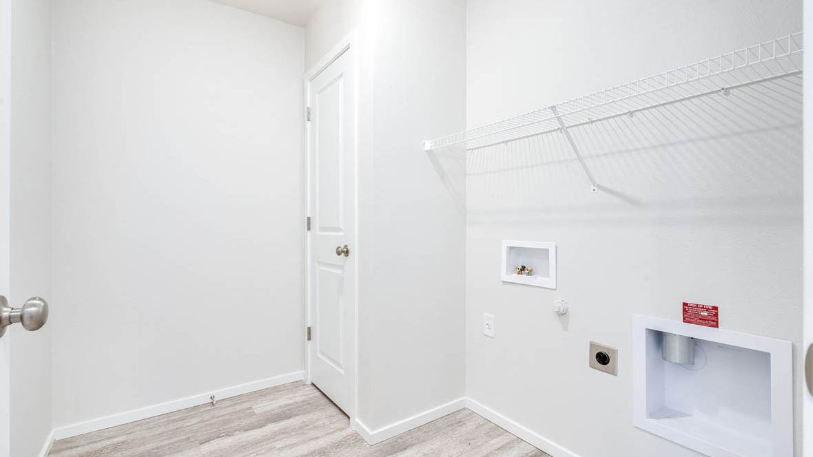 East Park Village laundry room with white wire shelving and white walls