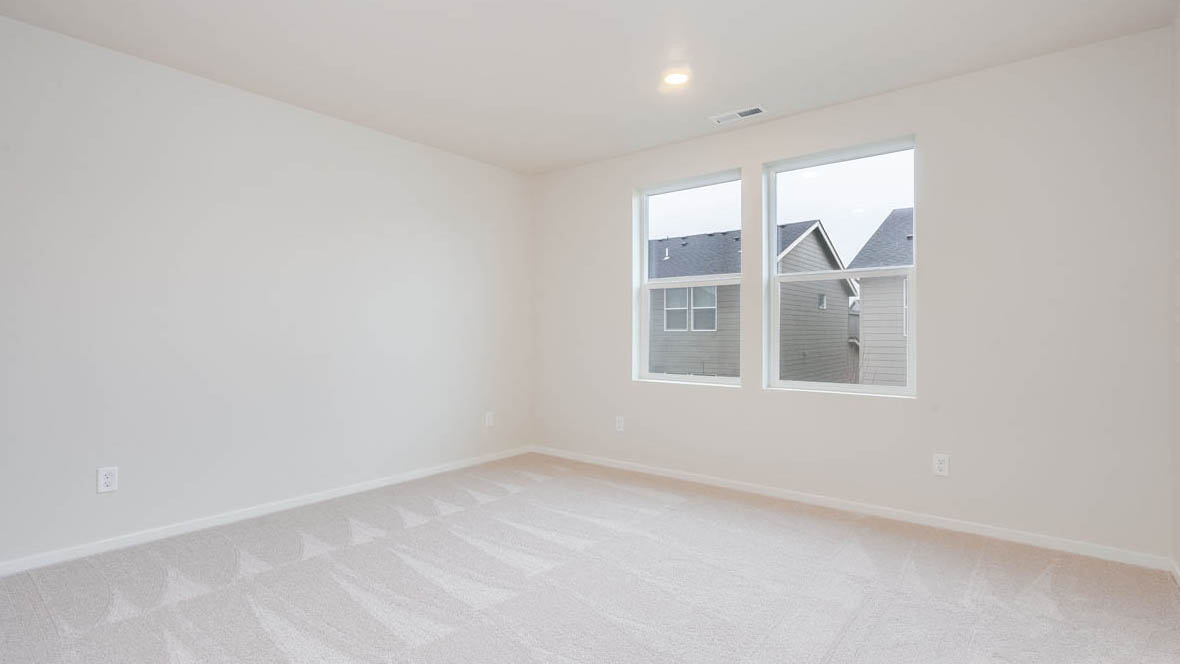 East Park Village primary bedroom with white carpeting, white walls and en suite bathroom