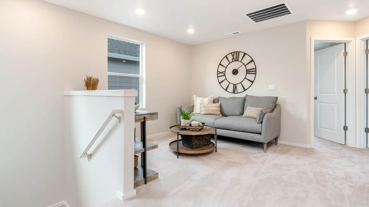 East Park Village Loft with carpet, stairs, cofee table, gray chair, big clock, and table with a window, and view of bedrooms
