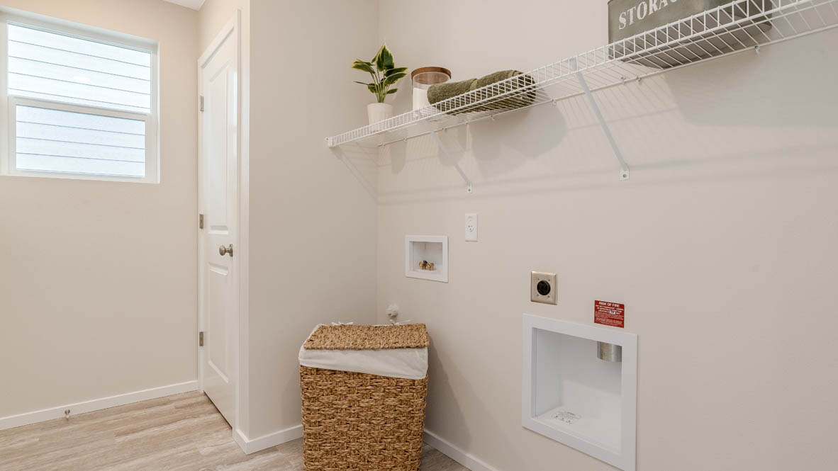 East Park Village Laundry Room with white wire shelving, a window
