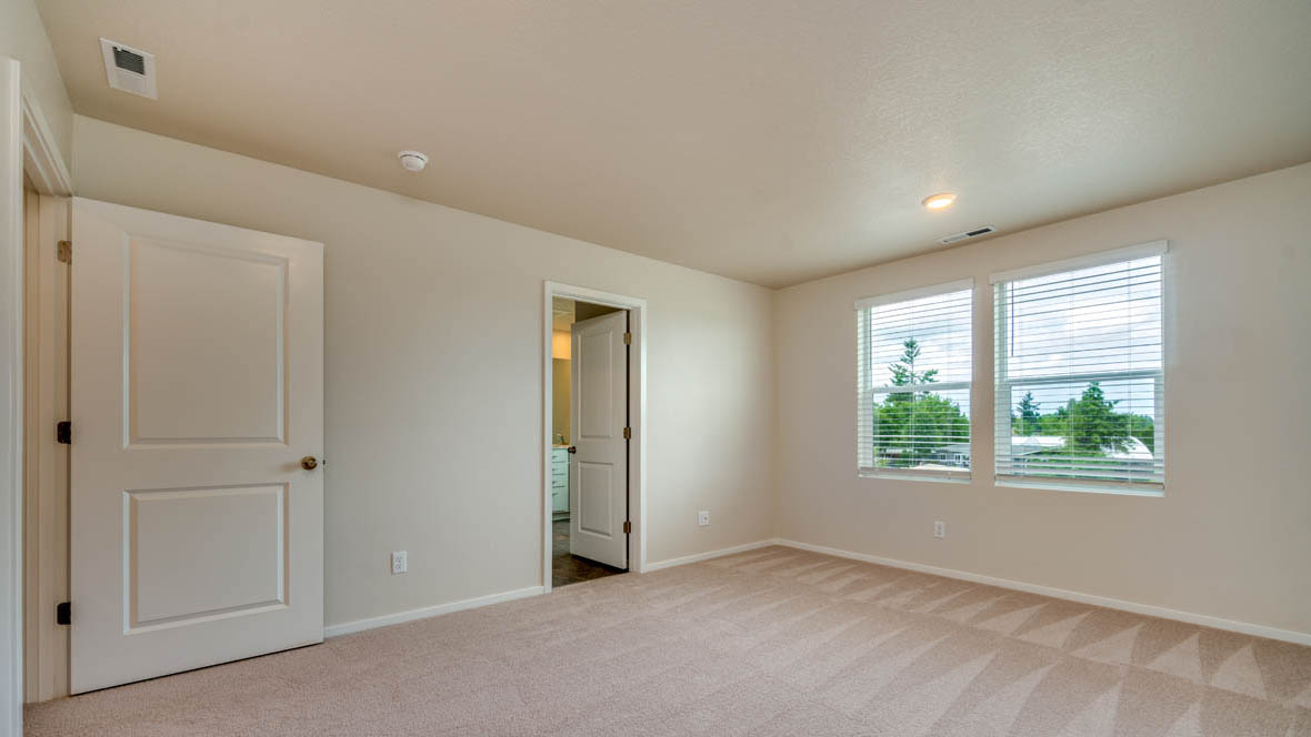 East Park Village bedroom with carpet, windows, and white walls