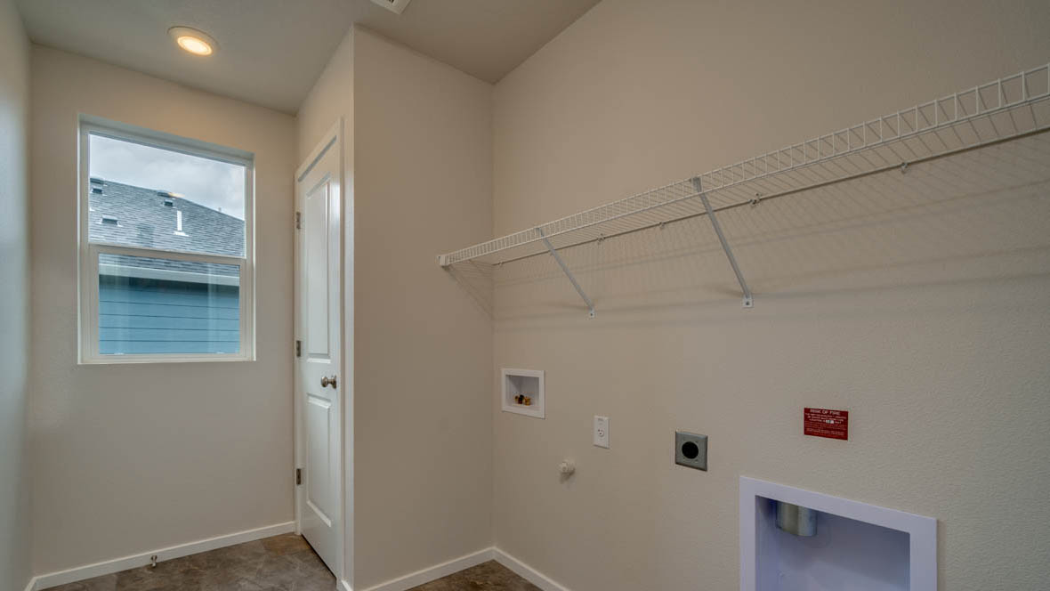 East Park Village laundry room with white wire shelving and window