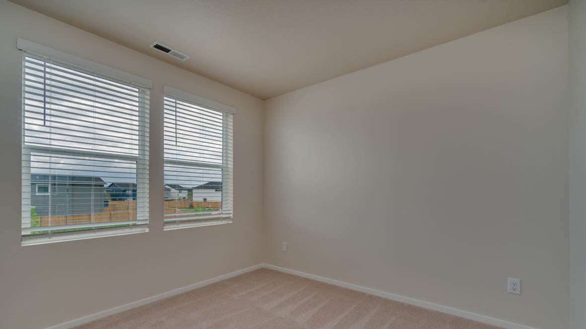 East Park Village bedroom with carpet, white walls, and windows