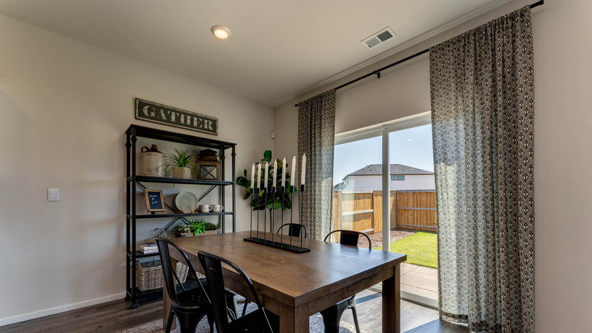 East Park Village dining area with laminate flooring, sliding glass door, and wood table