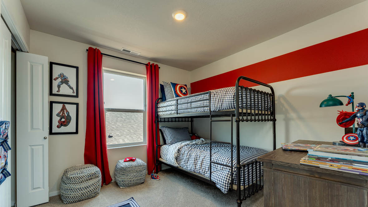 East Park Village bedroom with carpet, window, accent wall, and dark furniture