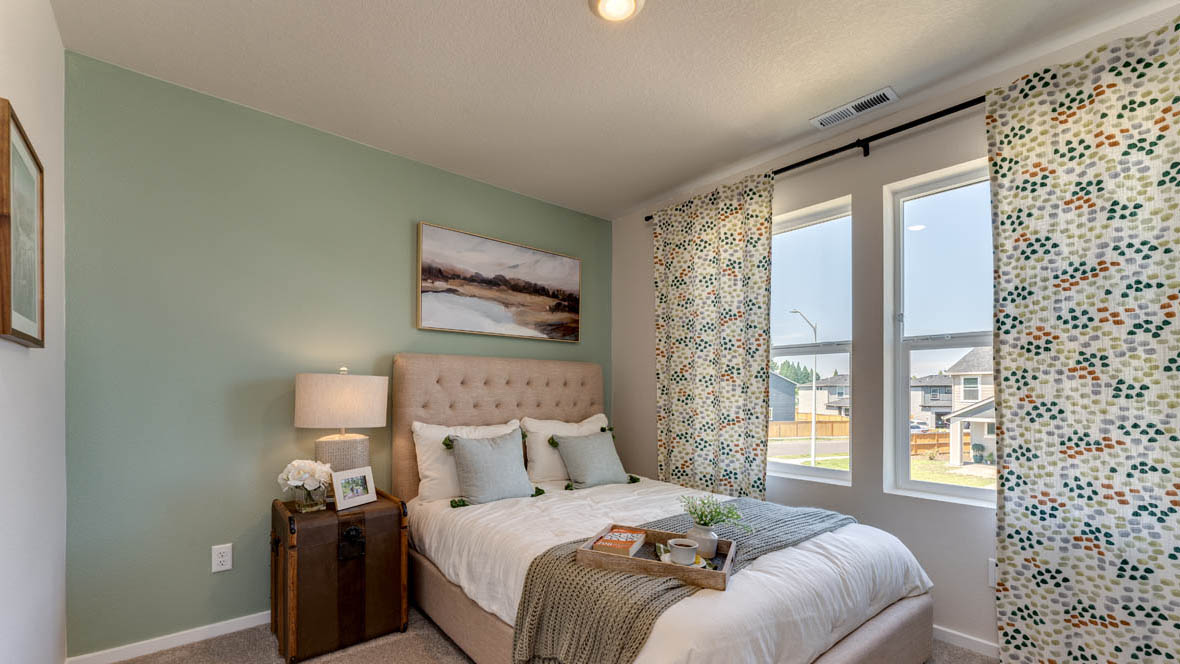 East Park Village bedroom with carpet, window, accent wall, and light colored furniture