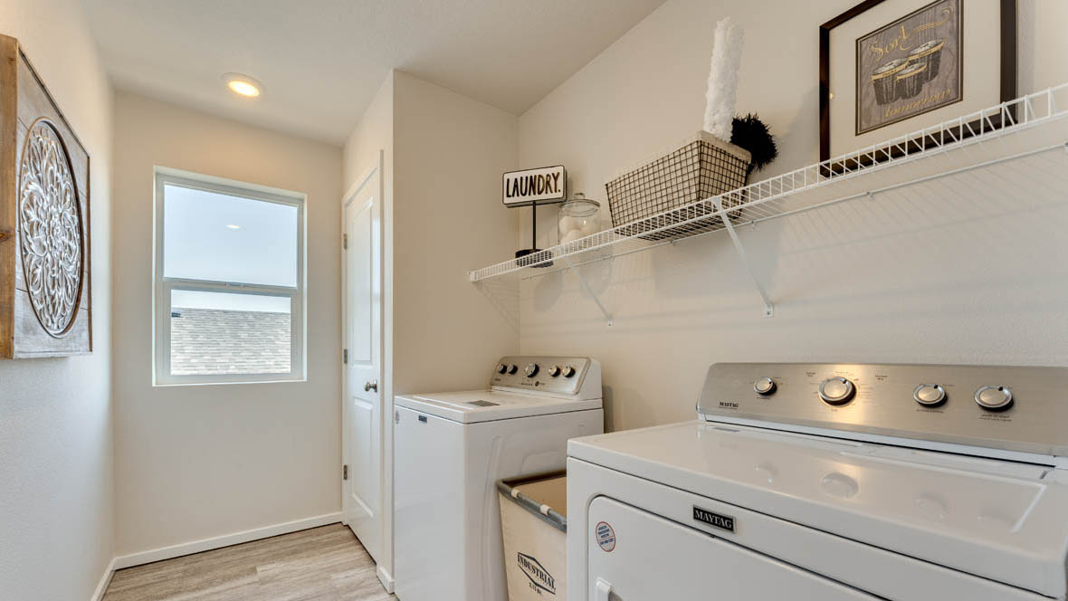 East Park Village laundry room white wire shelving and window