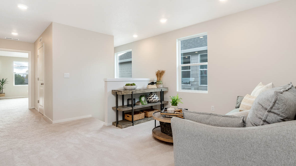 East Park Village Loft with carpet, stairs, cofee table, gray chair, big clock, and table with a window, and view of bedrooms