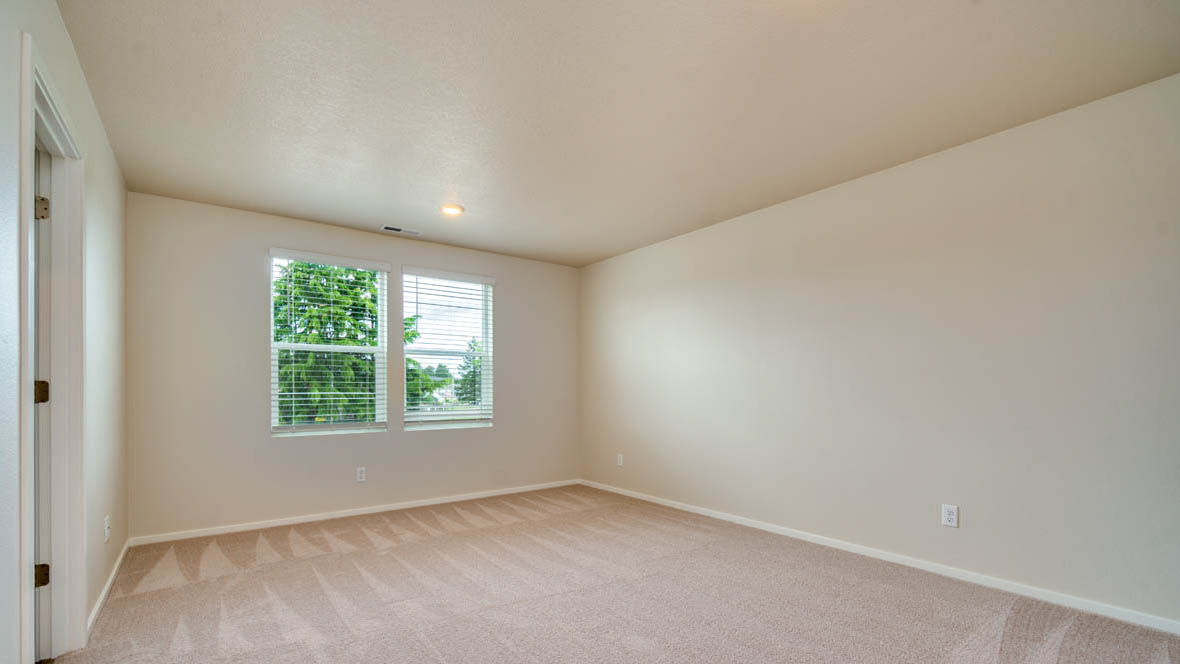 East Park bedroom with window, carpet, and white walls