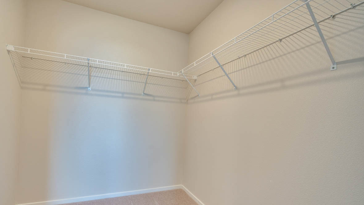 East Park walk in closet with white wire shelving and carpet