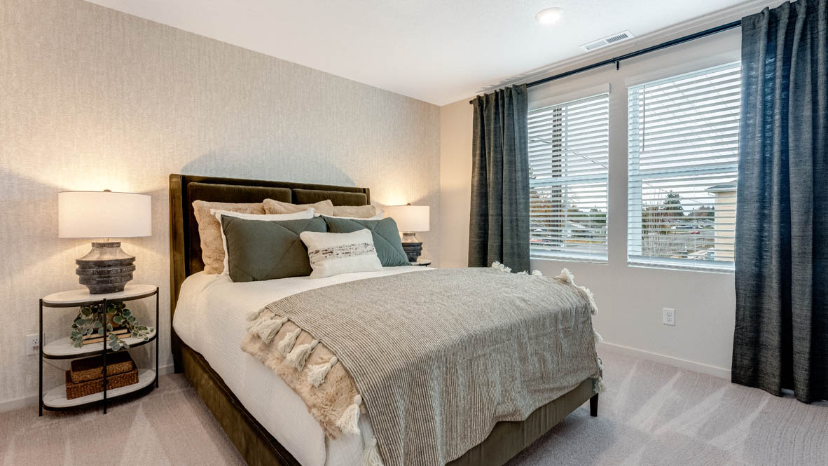 East Park Village Primary Bedroom with carpet, blue curtains, lamps with end tables, and bedding