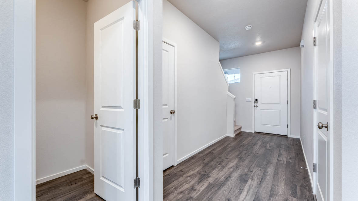 East Park VIllage Entry with powder room, laminate flooring, and white walls