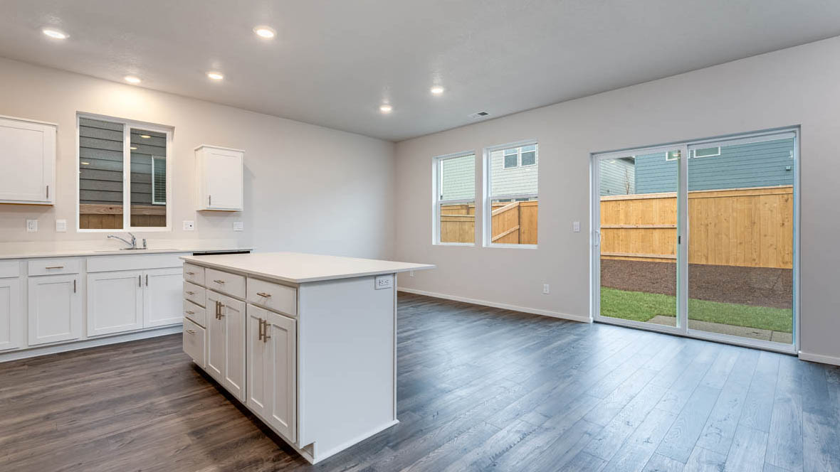 East Park Village dining room with island, laminate flooring, and windows with sliding glass door