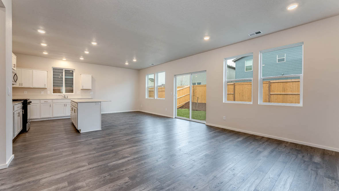 East Park Village Great room with island, laminate flooring, and windows with sliding glass door