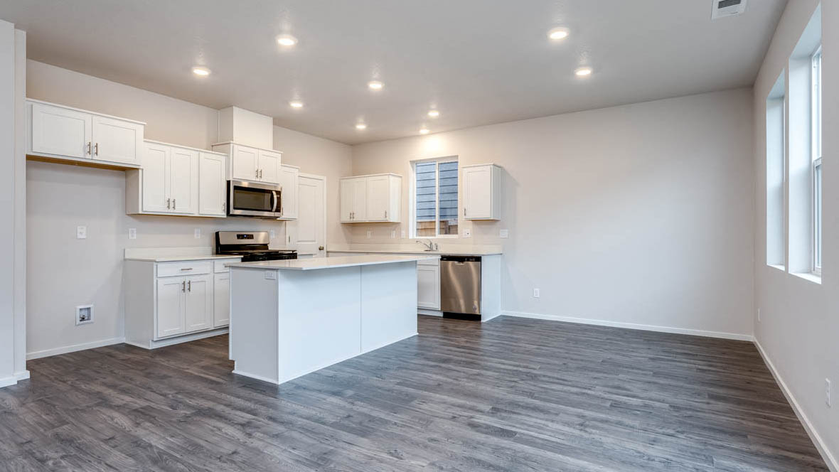 East Park Village Great room with island, laminate flooring, and windows with sliding glass door