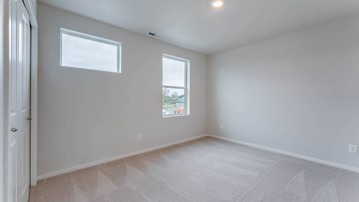 East Park Village bedroom with carpet, windows, and white walls