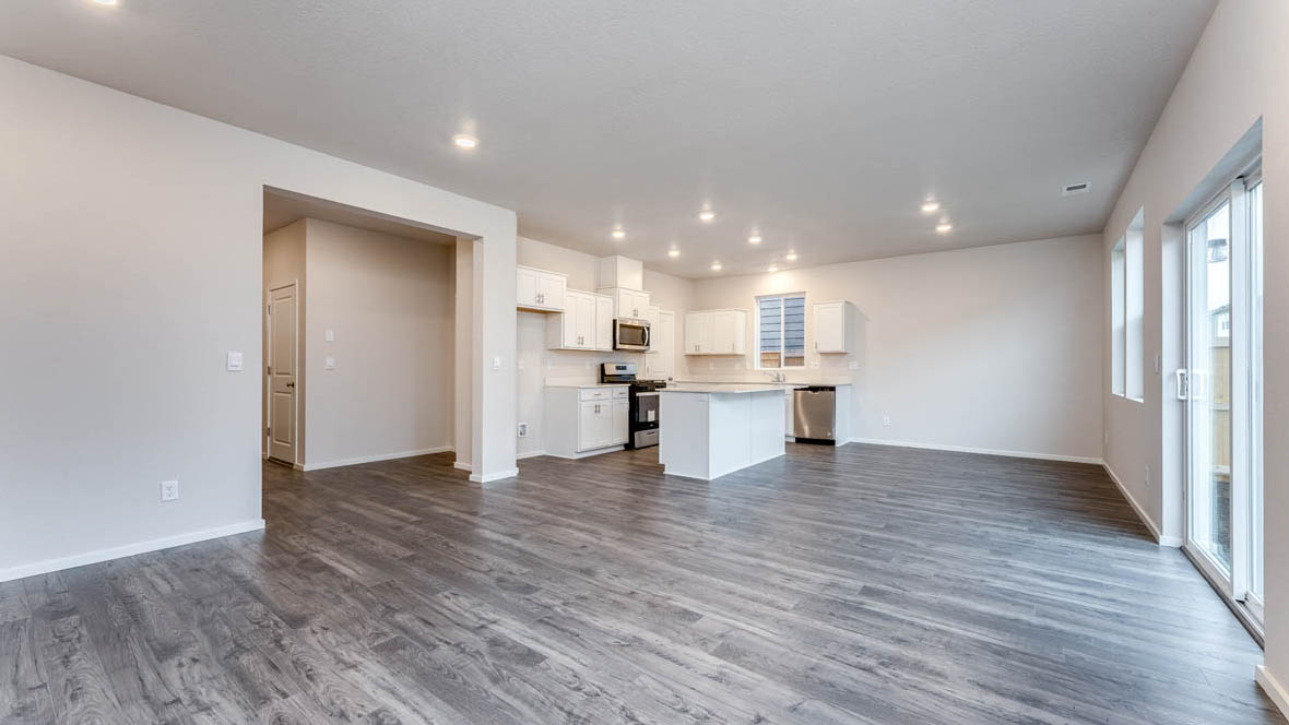 East Park Village Great room with island, laminate flooring, and windows with sliding glass door