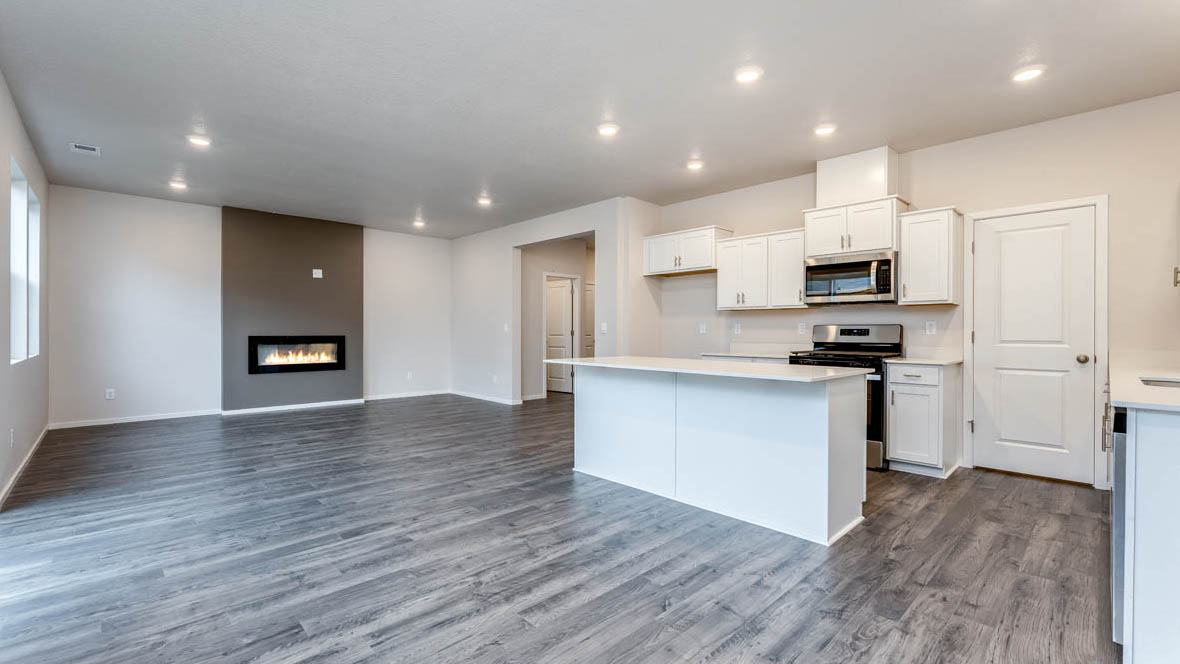 East Park Village kitchen with stainless steel appliances, island, window, cabinets, and laminate flooring