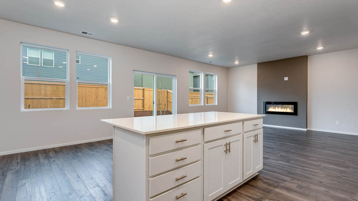 East Park Village kitchen with stainless steel appliances, island, window, cabinets, and laminate flooring