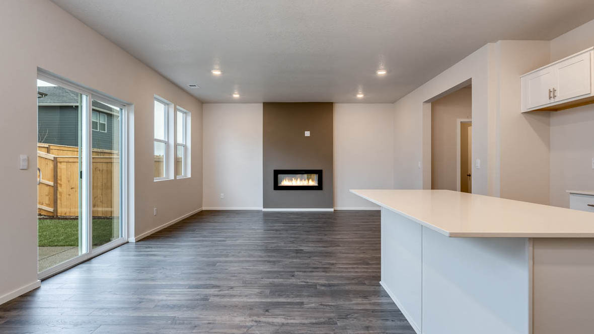 East Park Village dining room with island, laminate flooring, and kitchen in the background