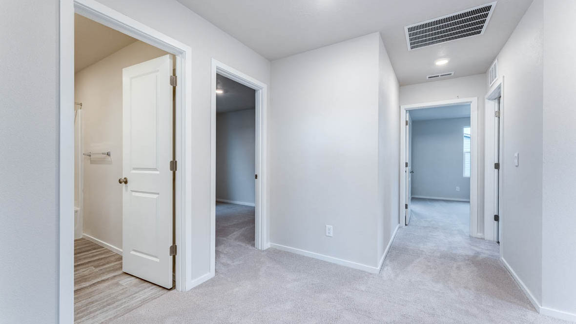 East Park Village hall with carpet, white walls, and bedroom doors