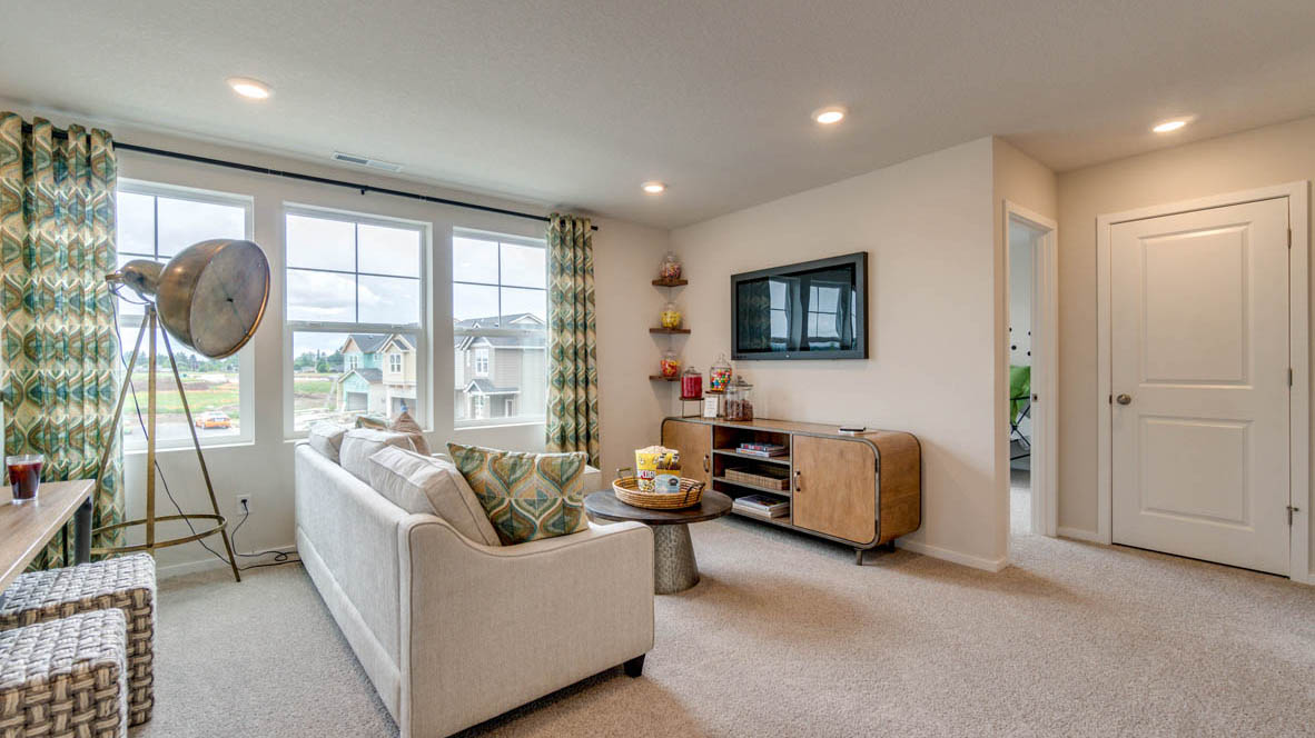 East Park Village Loft space with sectional couch, light carpeting, and an entertainment unit