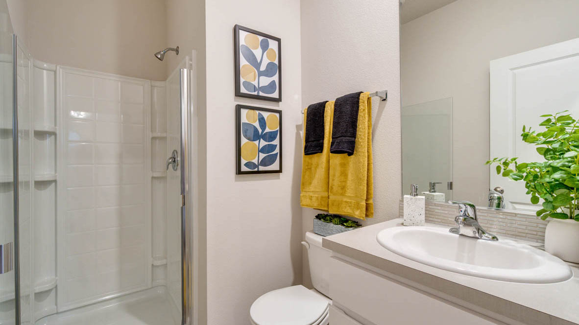 East Park Village Bathroom with single sink vanity and yellow accents