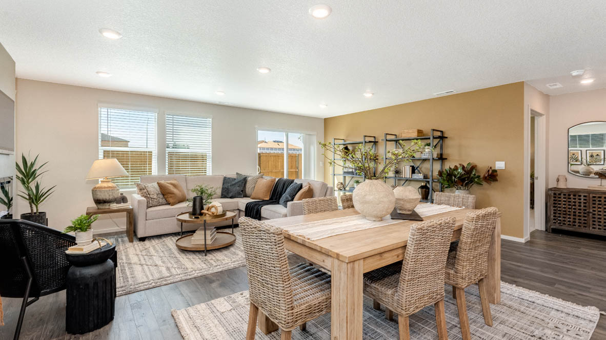 East Park Village dining room with carpet, laminate flooring, table with six dining chairs, black chair, and carpet, and view of great room