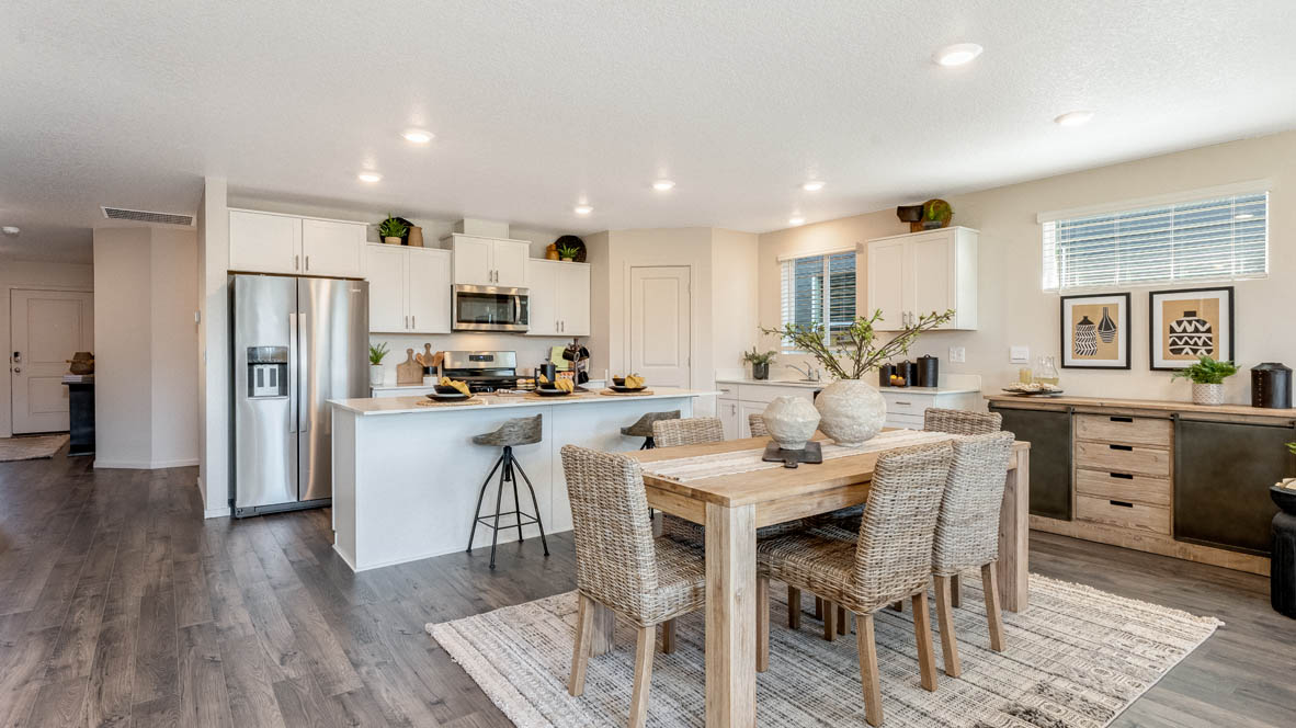 East Park Village dining room with carpet, laminate flooring, table with six dining chairs, black chair, and carpet, and view of kitchen