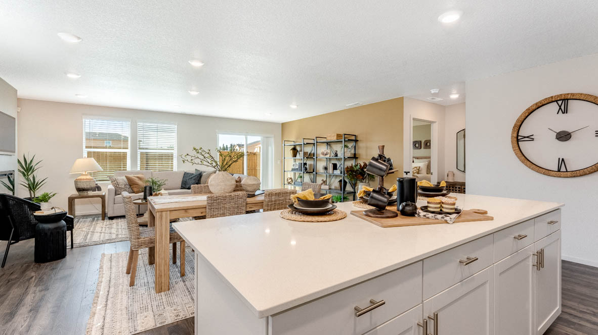 East Park Village Kitchen with quartz countertops, white cabinets, windows, pantry, and view of dining room, and great room