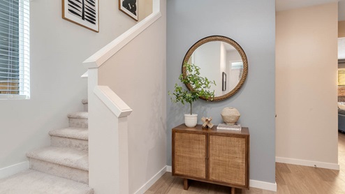 Misty Meadows Entry with round mirror and accent wall