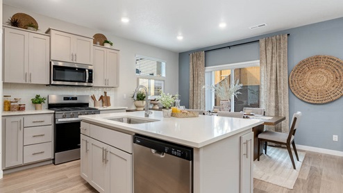 Misty Meadows kitchen with island and painted shaker style cabinets with stainless steel appliances